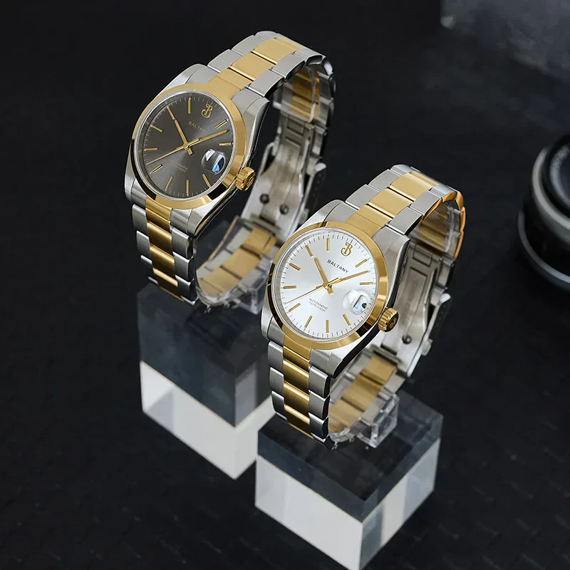 Elegant two-tone metal wristwatches with gold and silver finishes.,.
