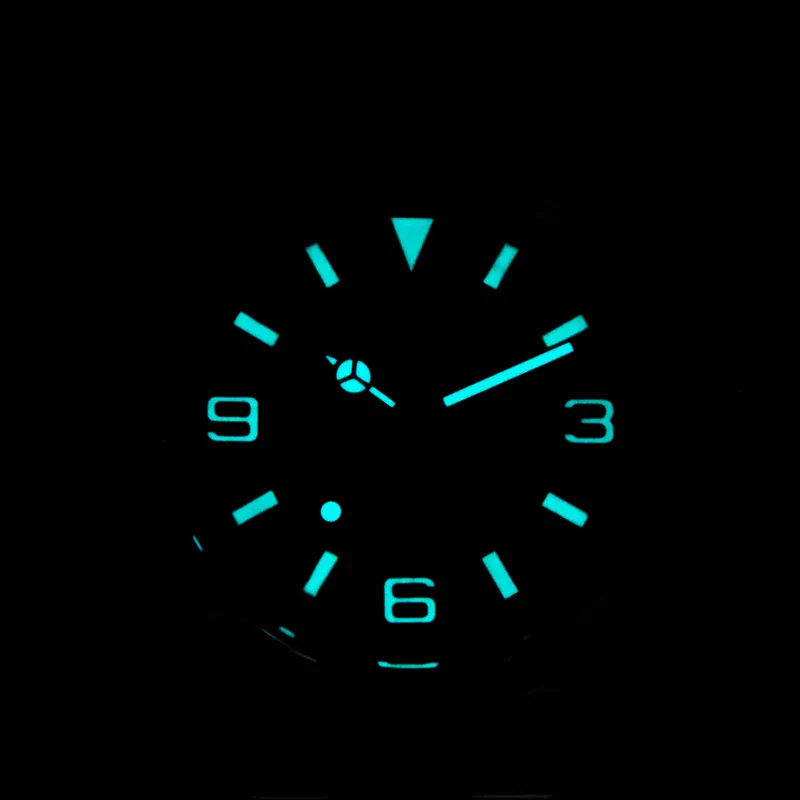 Glow-in-the-dark watch with illuminated numerals and hands in a dark setting.