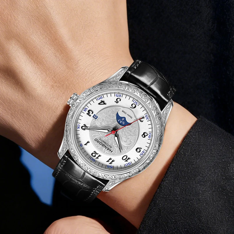 Luxurious men's silver wristwatch featuring moon phase complication and engraved design, leather strap.