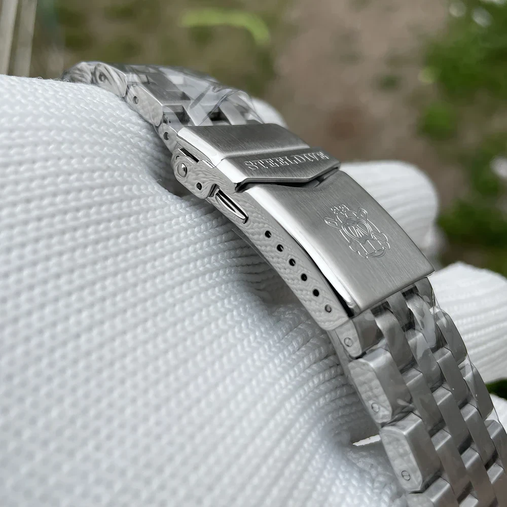 Stainless steel dive watch with ceramic bezel and luminous dial.