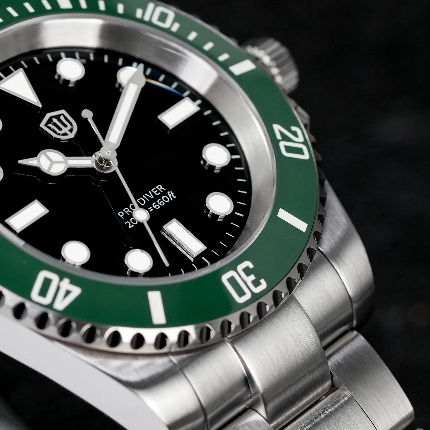 Diver's watch with green bezel, stainless steel bracelet, and 200M water resistance.