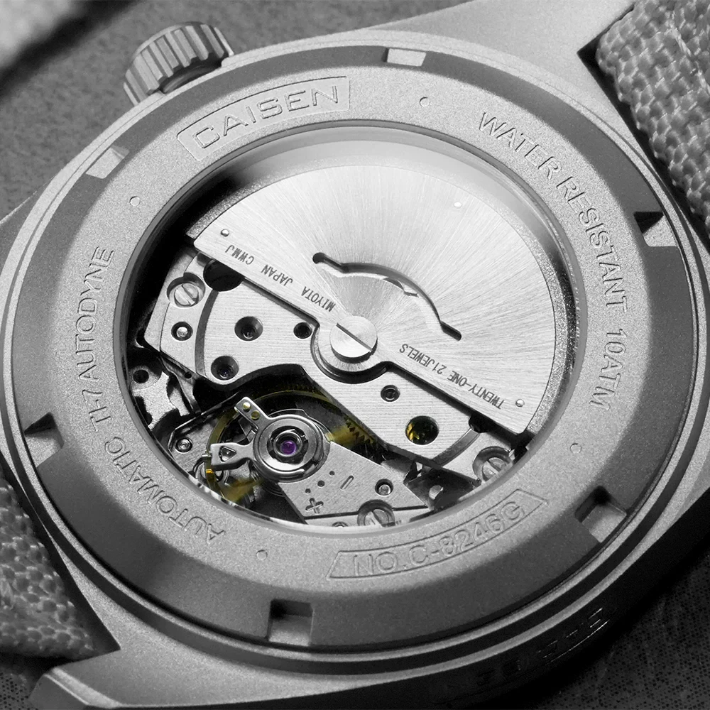 Autodyne TI-7 watch movement with visible mechanical parts and luminous features.