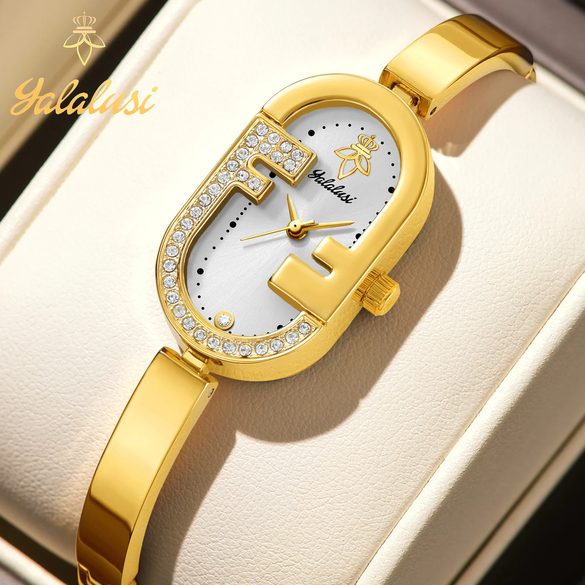 Rhinestone bracelet watch with slim oval dial, gold-tone finish, elegant design for women.