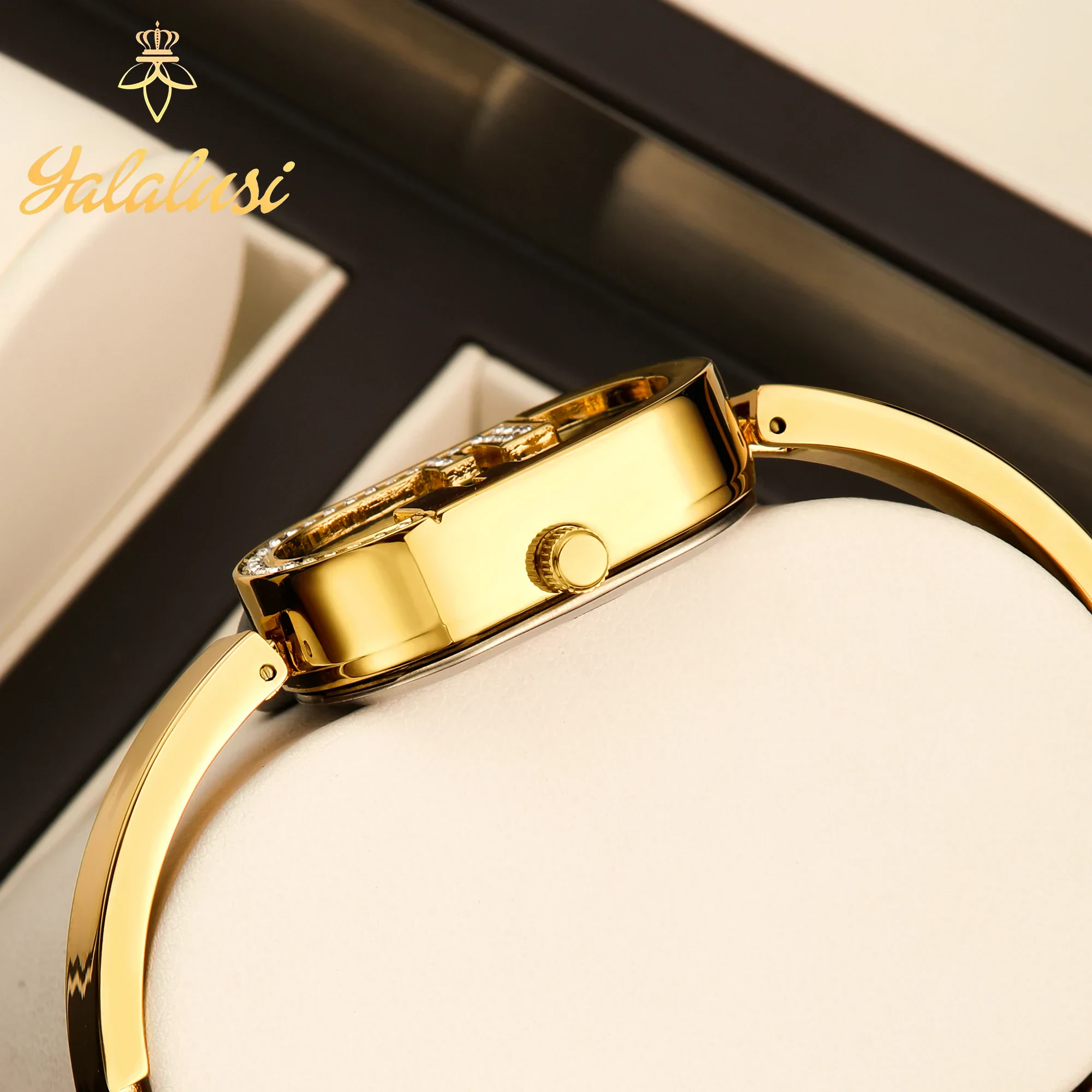 Elegant oval dial gold-tone bracelet watch with rhinestones.