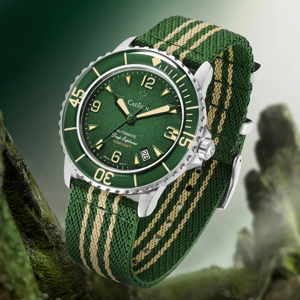 Automatic mechanical wristwatch with green dial and canvas strap.