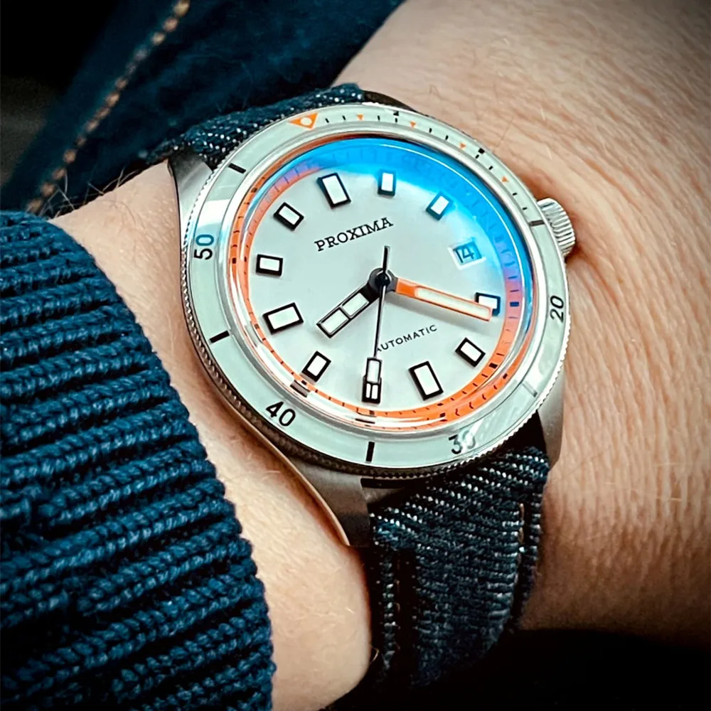 Diver watch with stainless steel case, sapphire bezel, luminous markers, and waterproof design.