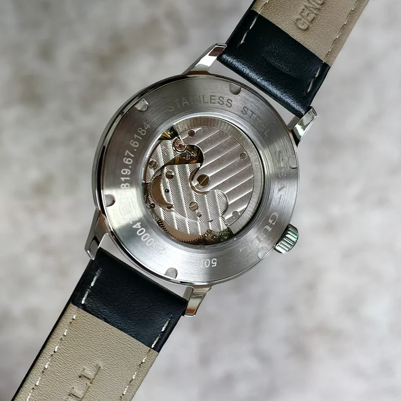 Automatic men's watch with blue sapphire glass and stainless steel case.