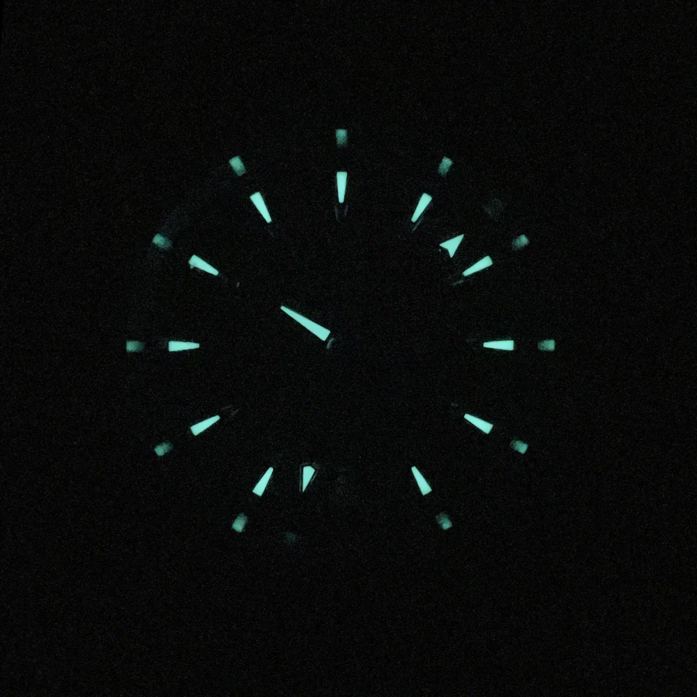 Luminous glow of Phylida 38mm matte black Aqua men's automatic watch in darkness.