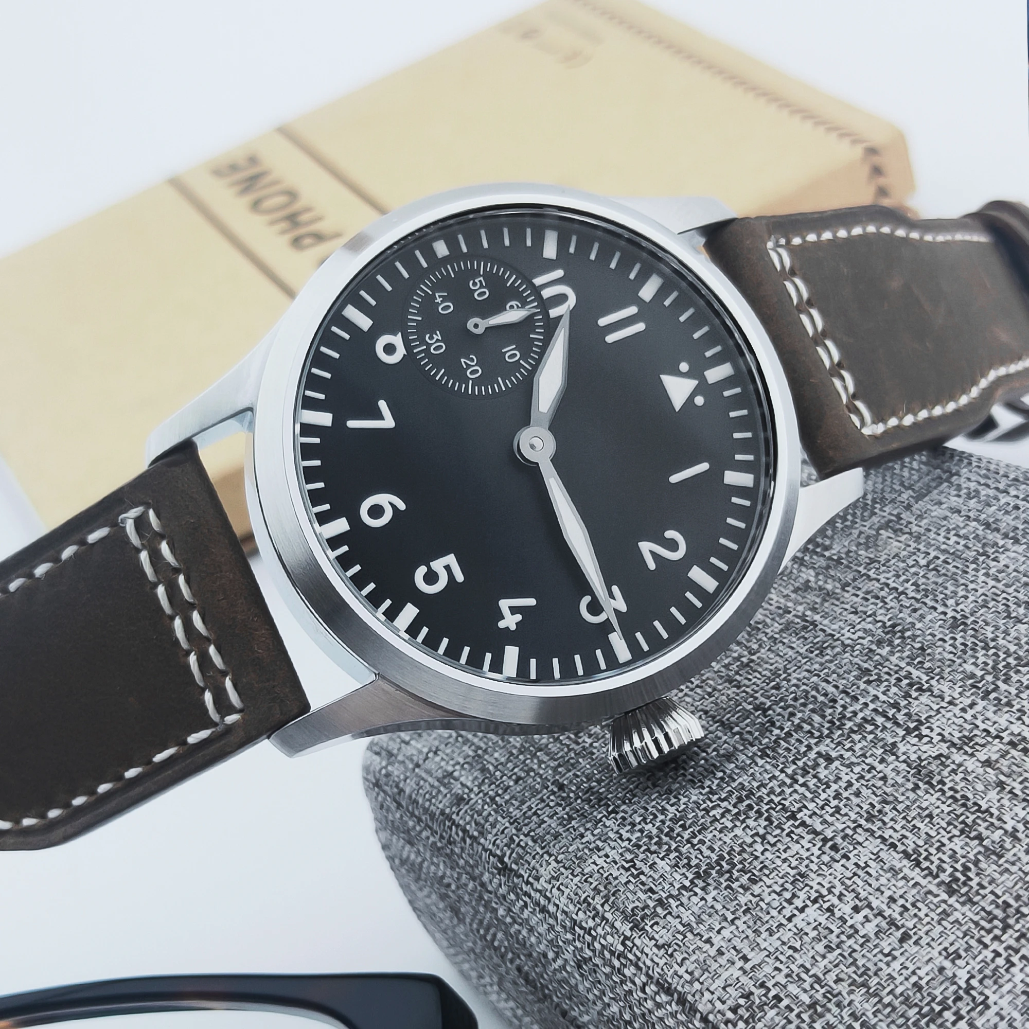 Elegant men's wristwatch with black dial, white numerals, and brown leather strap for classic style.
