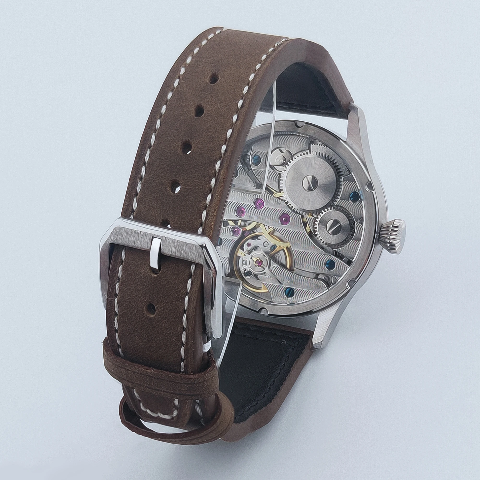 Luxury mechanical wristwatch with brown leather strap and visible gears.