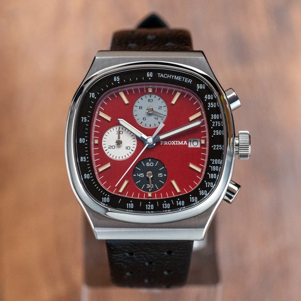 Vintage Proxima chronograph watch with red dial and leather strap.