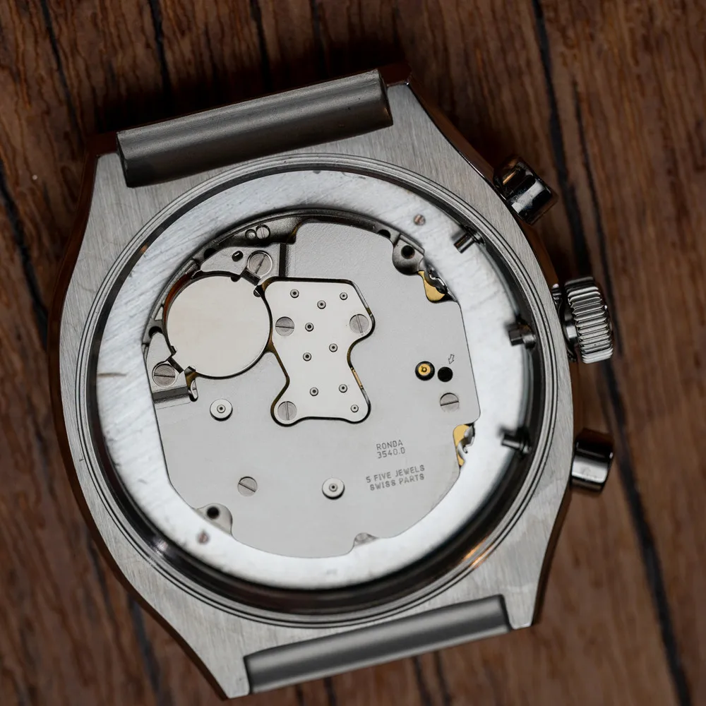 Close-up of a watch case back showcasing mechanical movement and intricate details.