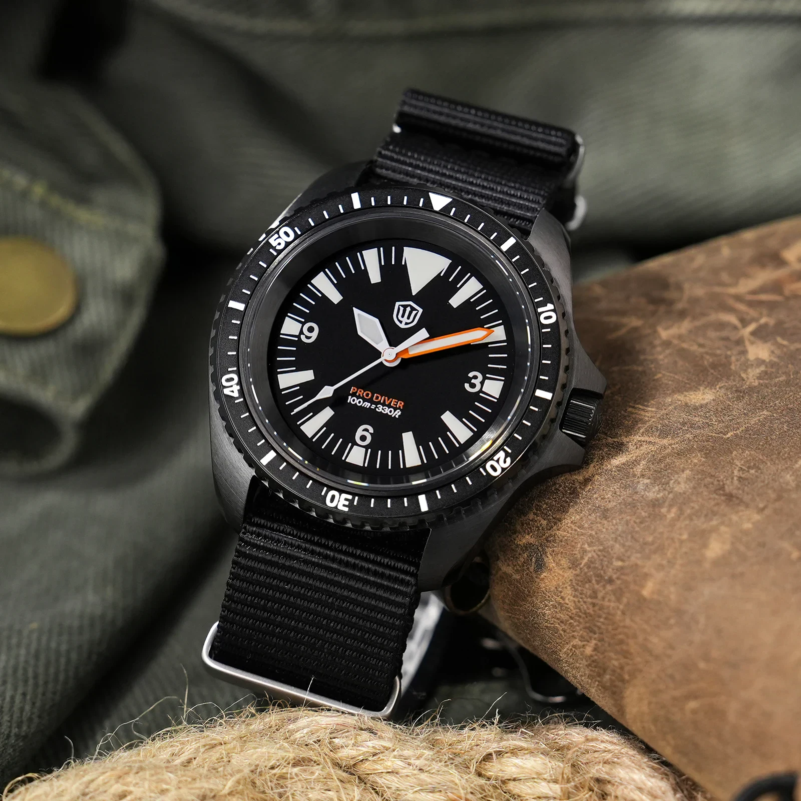 Diver's watch featuring a black dial, orange second hand, and durable black strap for underwater adv.
