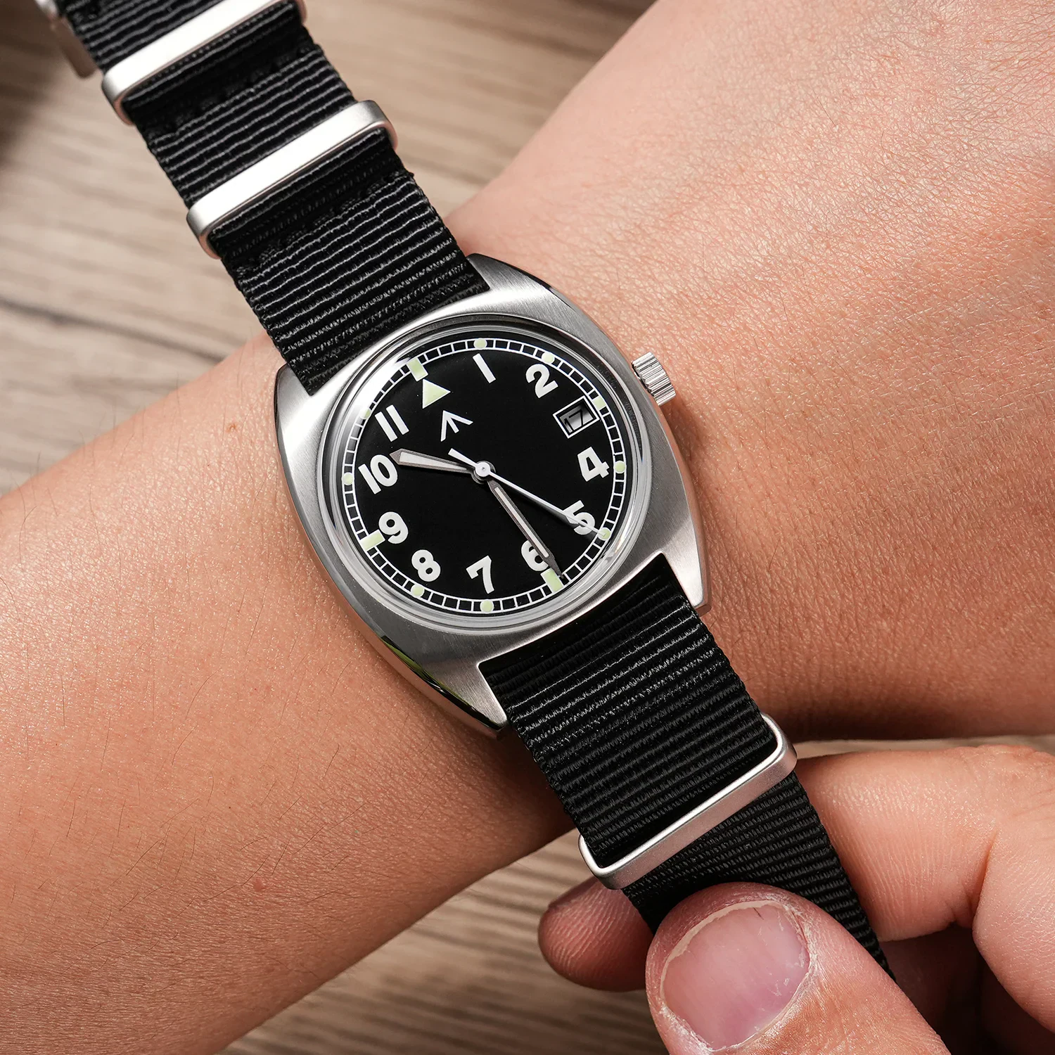 Wristwatch with black dial and NATO strap, casual style, durable design, suitable for everyday wear.