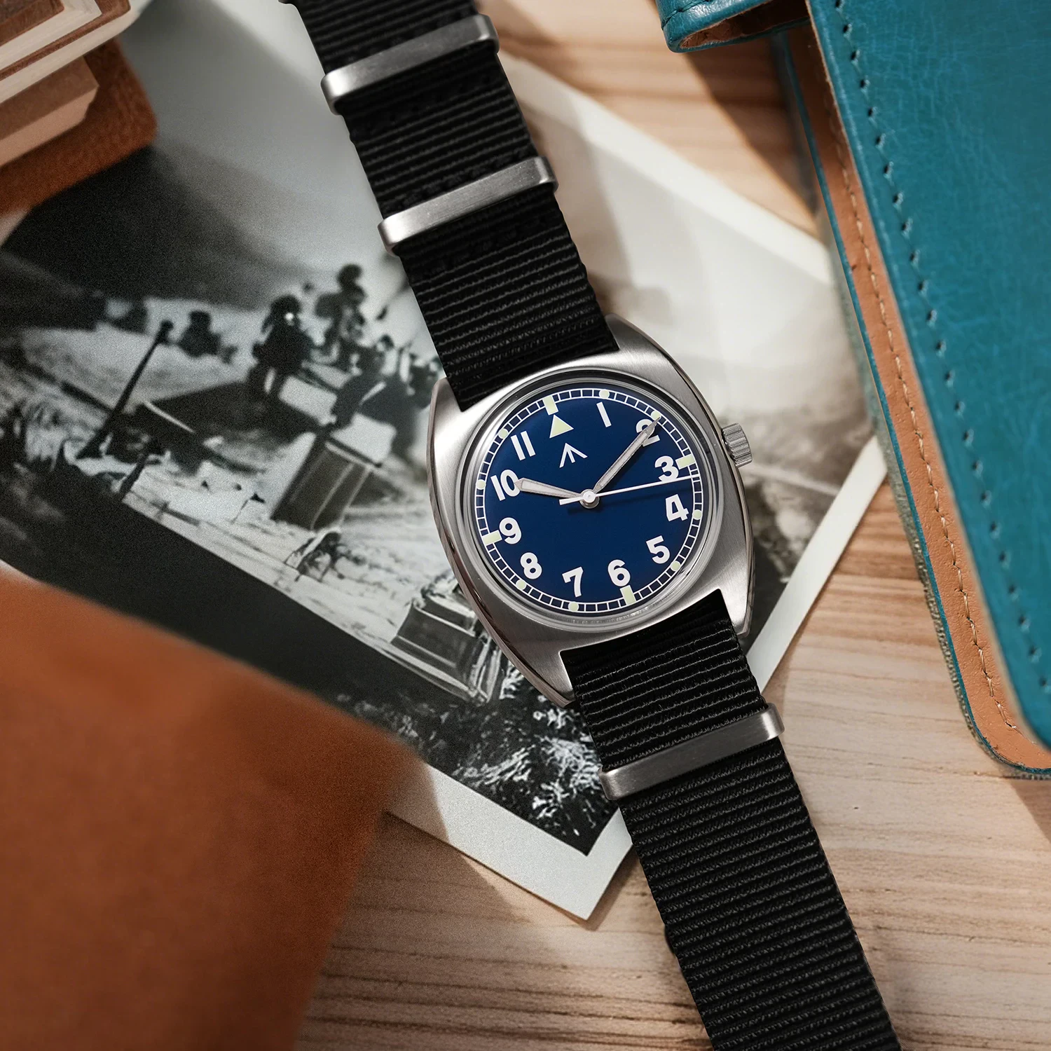 Men's military wristwatch with black nylon strap and blue dial.