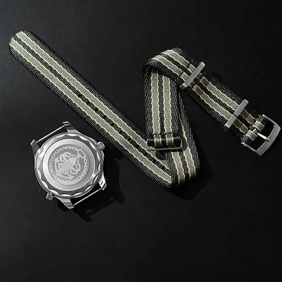 Stylish watch with striped NATO strap and engraved case back for a modern look.