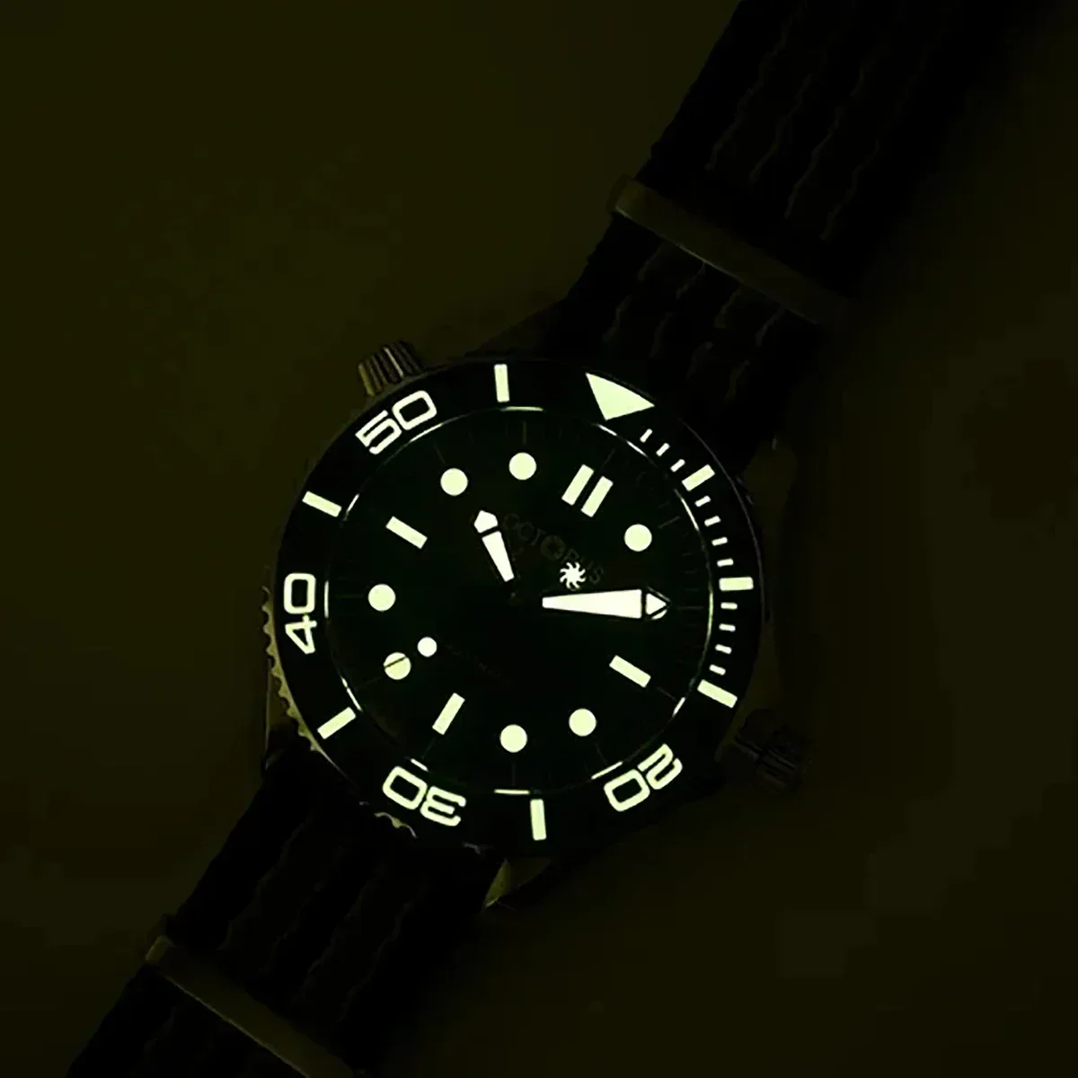 Luminous diver's watch with glow-in-the-dark dial and black rubber strap for underwater use.
