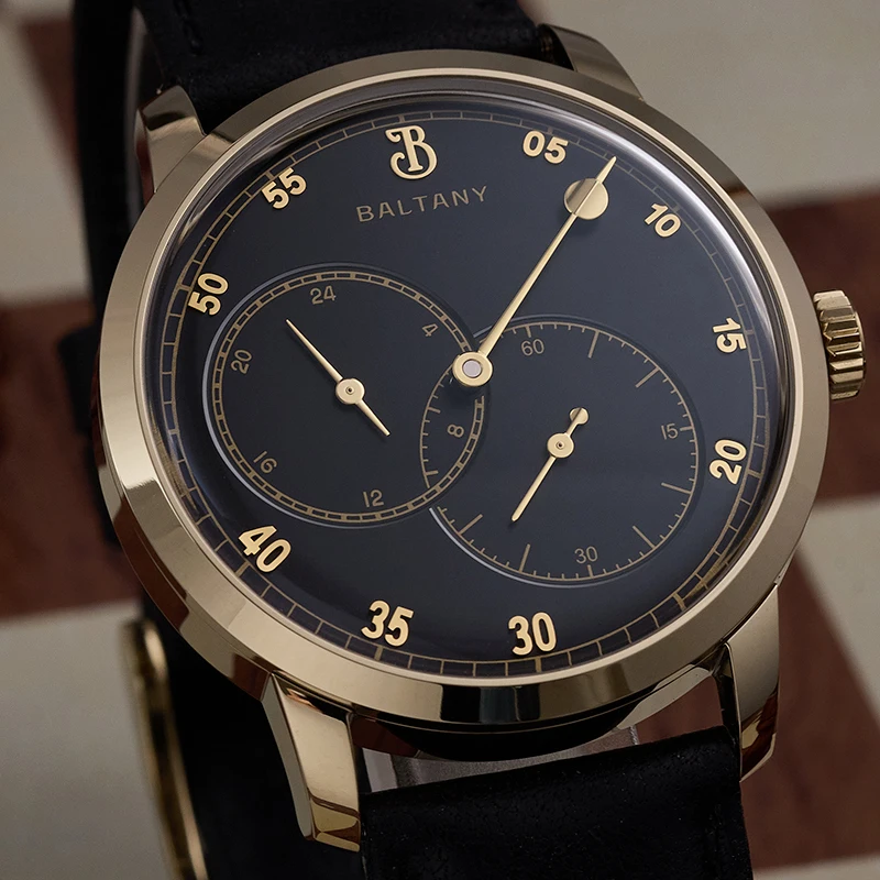 Elegant men's wristwatch with dual chronograph dials and gold accents.