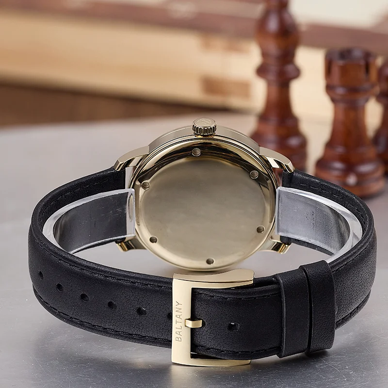 Elegant black leather watch with gold case and buckle, stylish accessory for men and women.