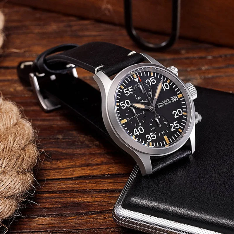 Men's black chronograph wristwatch with leather strap and multiple dials.