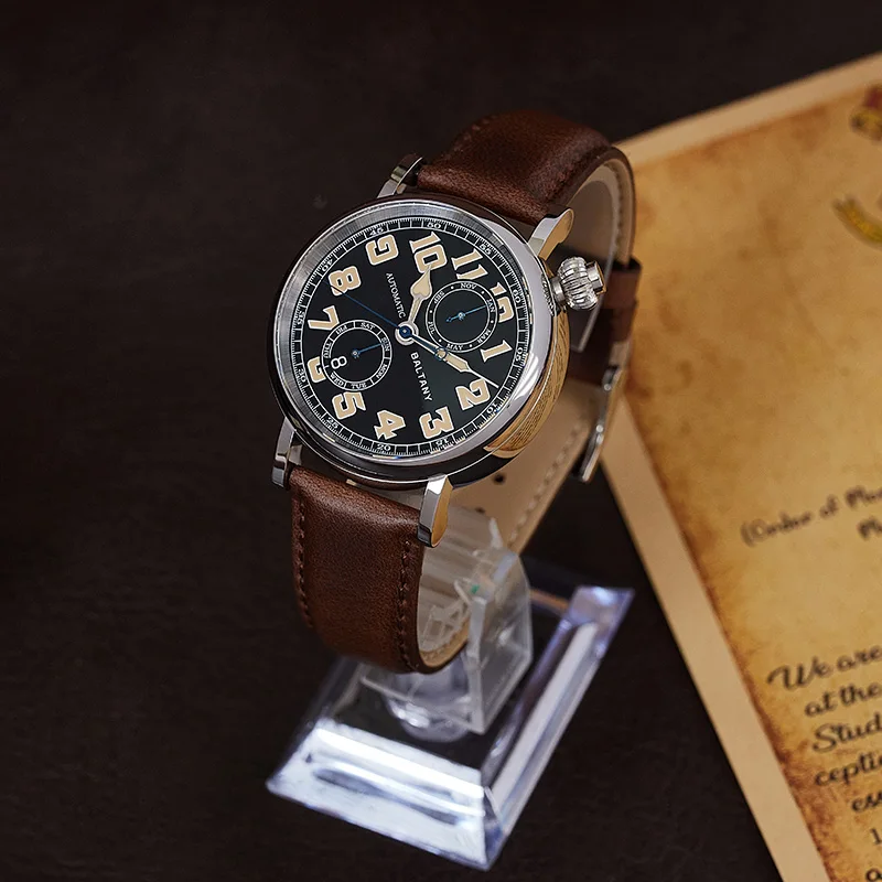 Men's luxury wristwatch with brown leather strap and vintage-style black dial.