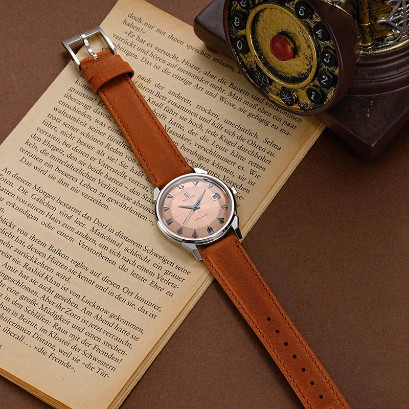 Leather strap watch with silver case and pink dial. Elegant and timeless accessory for everyday wear.