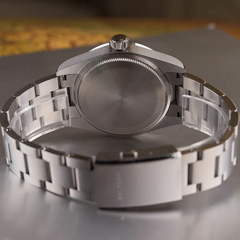Stainless steel wristwatch with metal bracelet and crown, minimalist design, no dial visible.