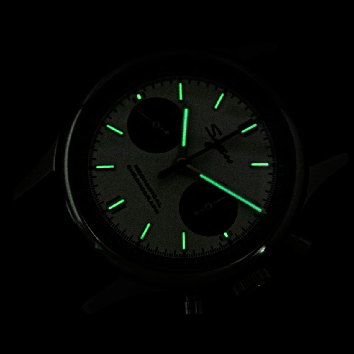 Luminous watch with glowing green hands and markers for night visibility.