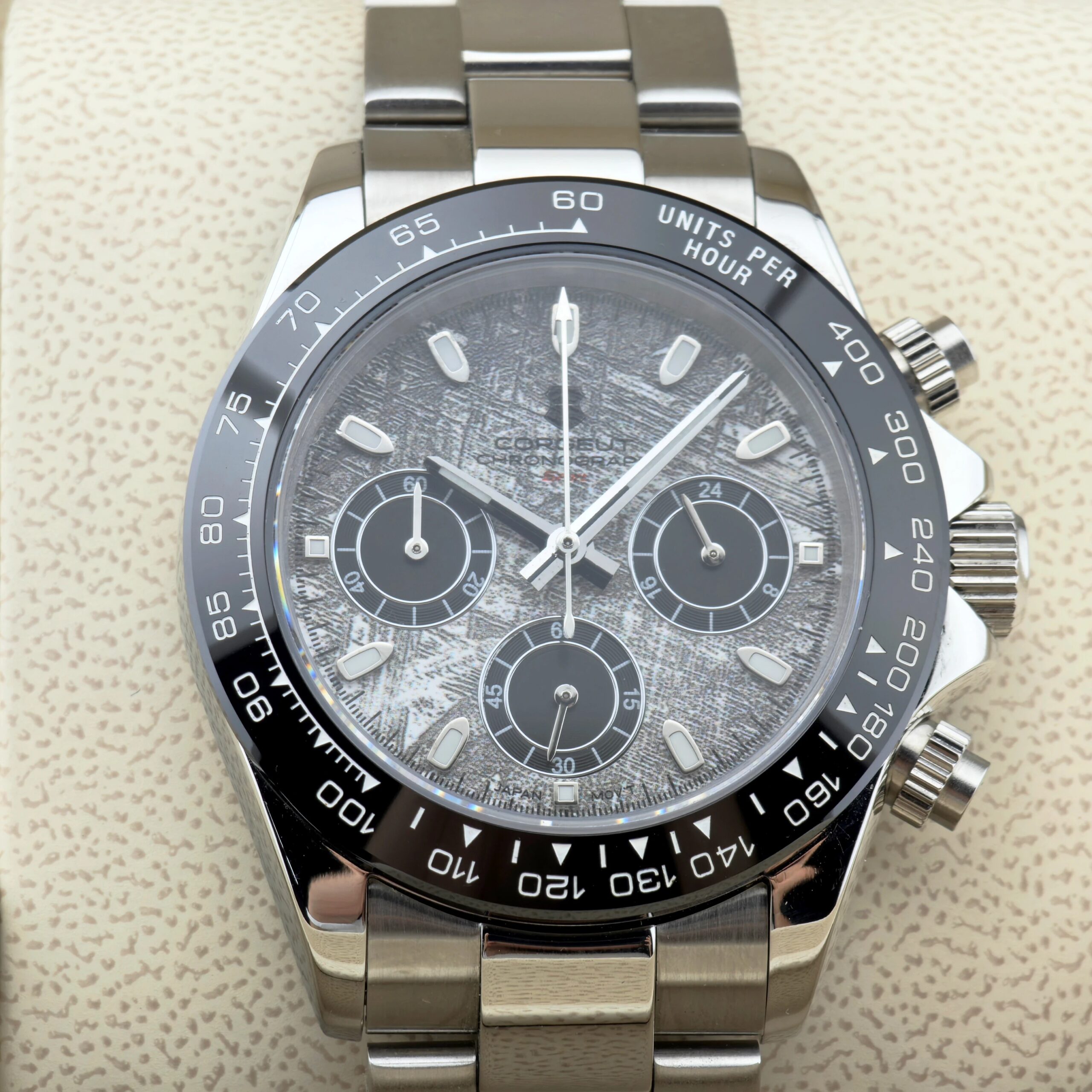 High-quality silver chronograph wristwatch with black bezel and multiple sub-dials.