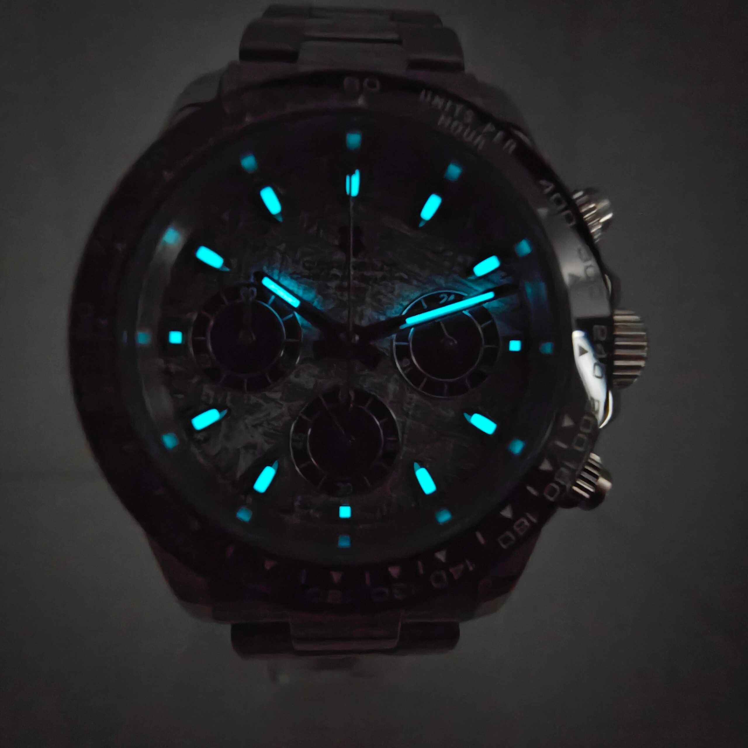Black chronograph watch with blue luminescent markers and subdials, stylish and functional accessory.