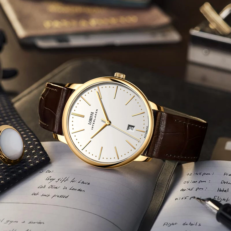 Luxury gold watch with brown leather strap and minimalist white dial.