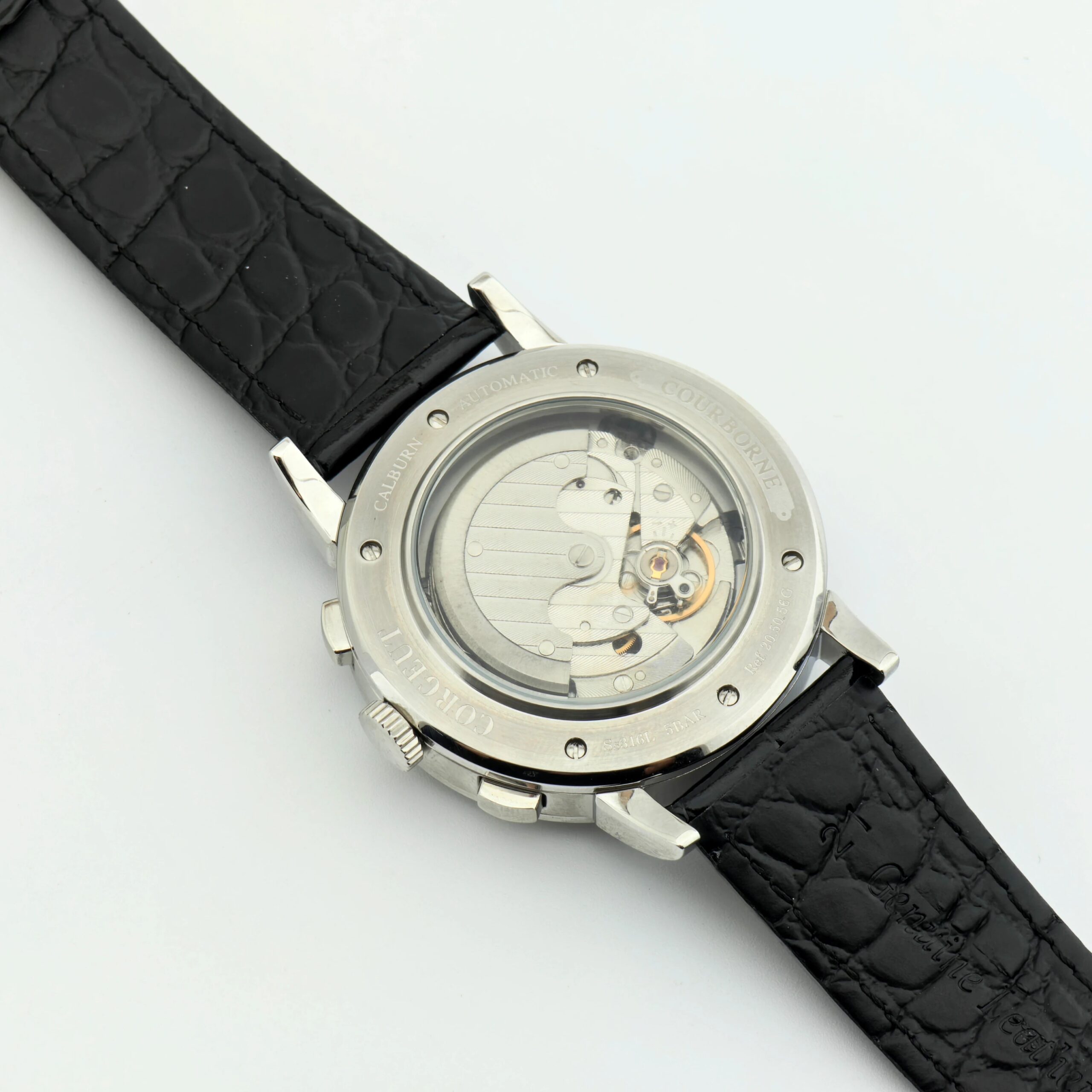 Skeleton watch showcasing intricate internal mechanics and silver case, paired with a textured black.
