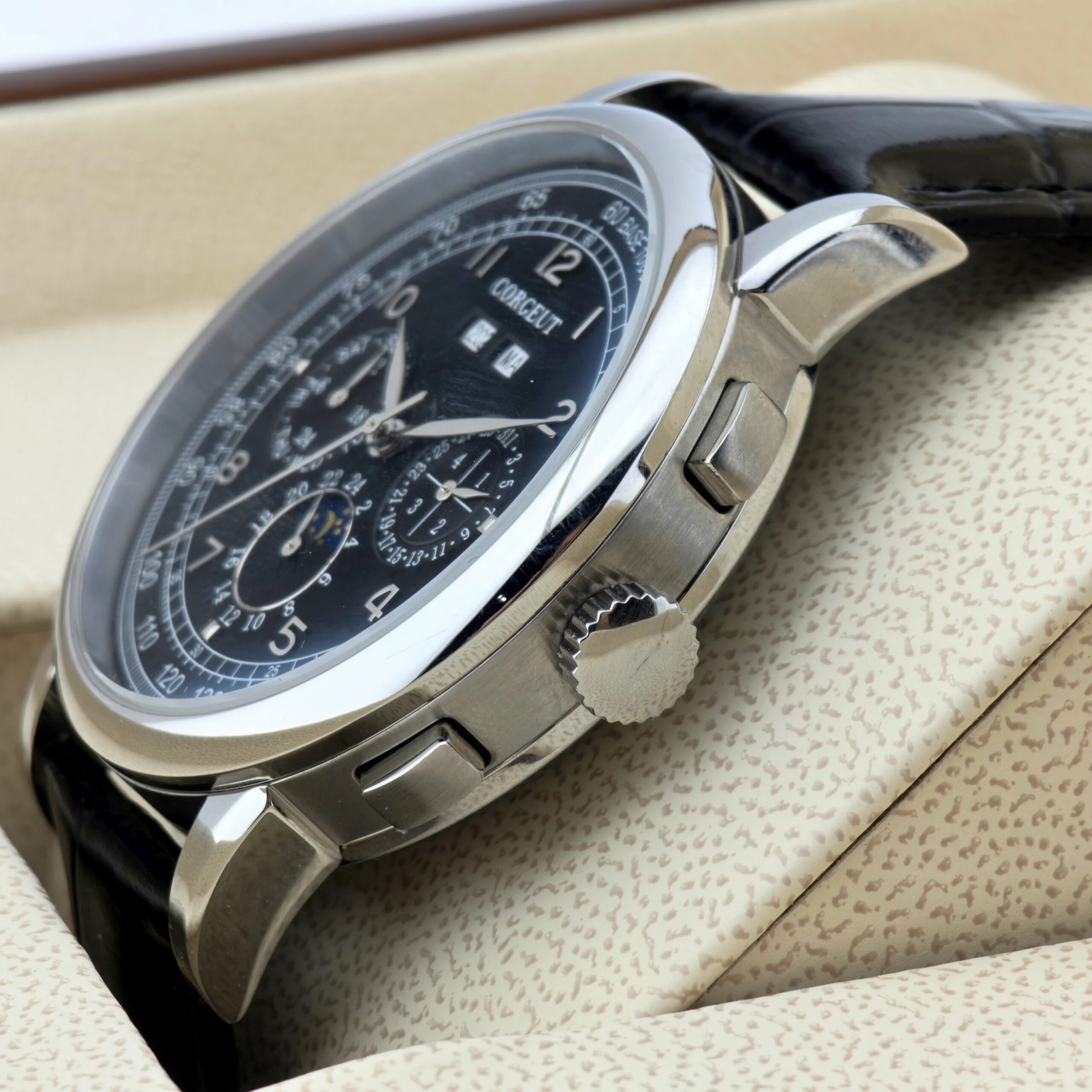 Men's luxury chronograph watch with black leather strap and silver case for elegant style.