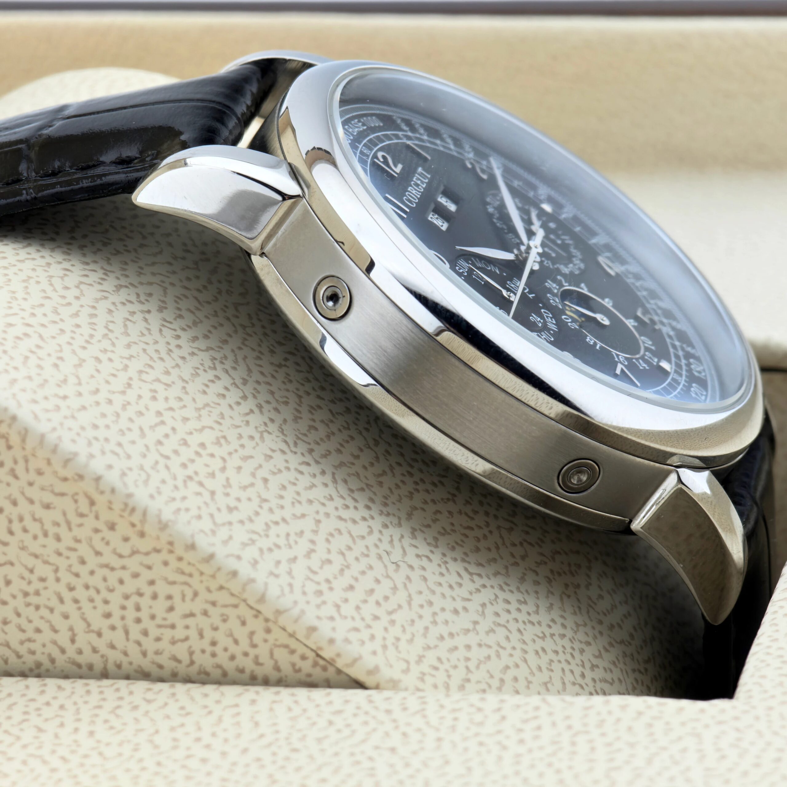 Elegant men's wristwatch with chronograph features and black dial.