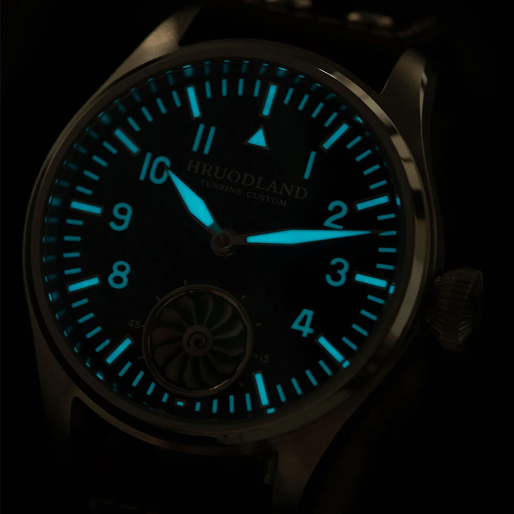 Luminous dial watch showing glowing blue hands and markers, perfect for night visibility and stylish.